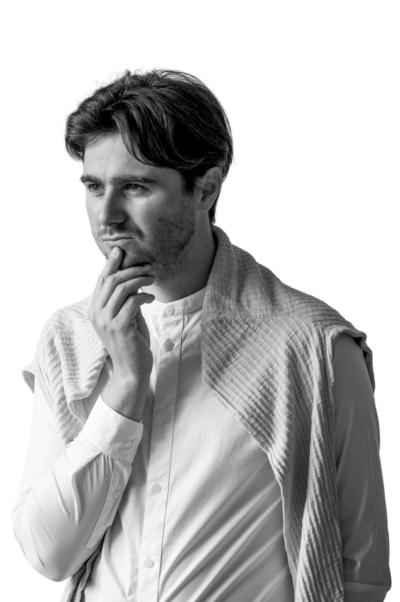 Black and white portrait of Vladas Novicki, hand on chin, wearing a white shirt with a sweater over his shoulders